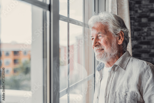 Behang Happy thoughtful older 70s man looking out of window away with hope, thinking of good health, retirement, insurance benefits, dreaming of future