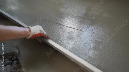 Wallpaper Mural Filling the floor with cement screed. Filling the floor of a renovated apartment with concrete, screed and leveling the floor by construction workers. Leveling the cement screed using the rule. Torontodigital.ca