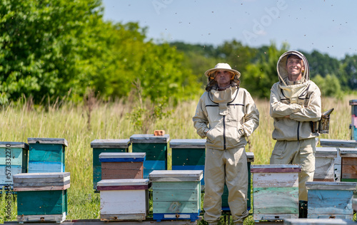 Beekeeping handsome specialists. Honey farming workers in apiary.