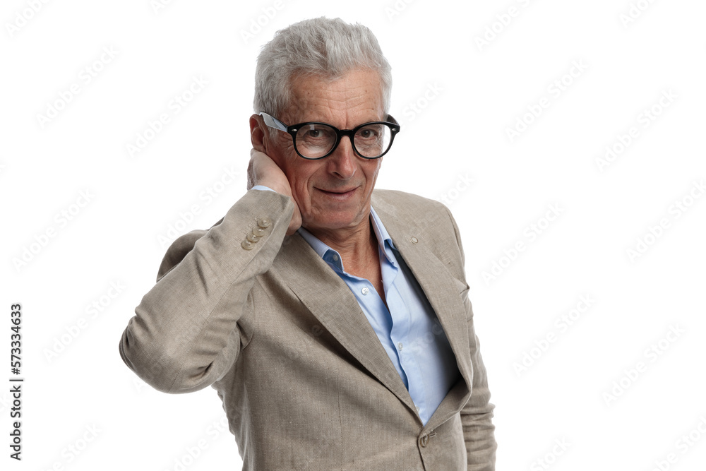 handsome man in his 60s with glasses holding hand behind neck