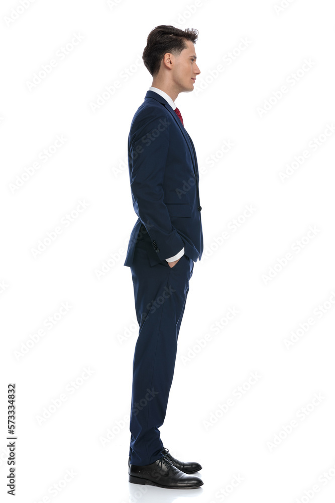 businessman waiting in line with hands in pockets businessman waiting in line with hands in pockets