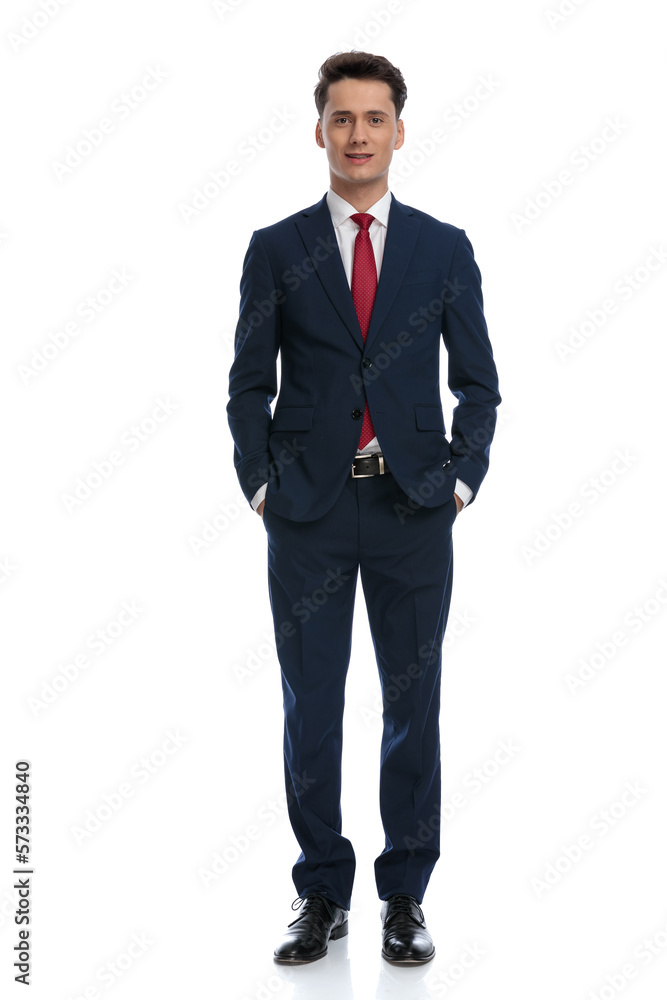 businessman with hands in pockets smiling businessman with hands in pockets smiling