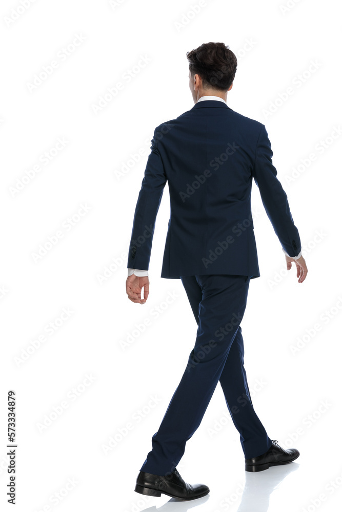 businessman walking one way and looking the other businessman walking one way and looking the other