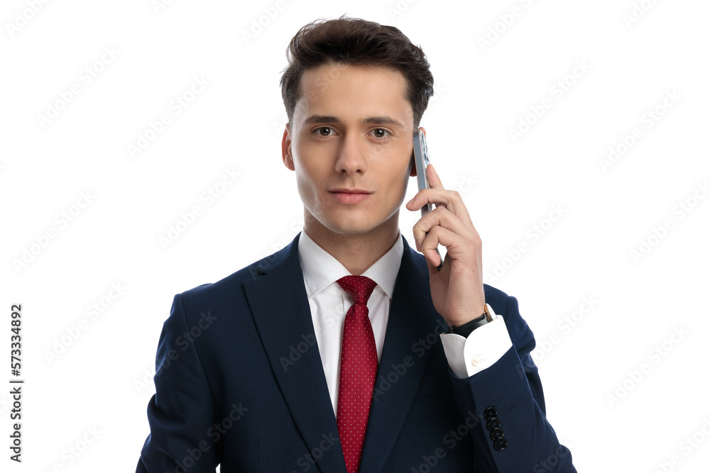 businessman talking on the phone and looking at camera businessman talking on the phone and looking at camera