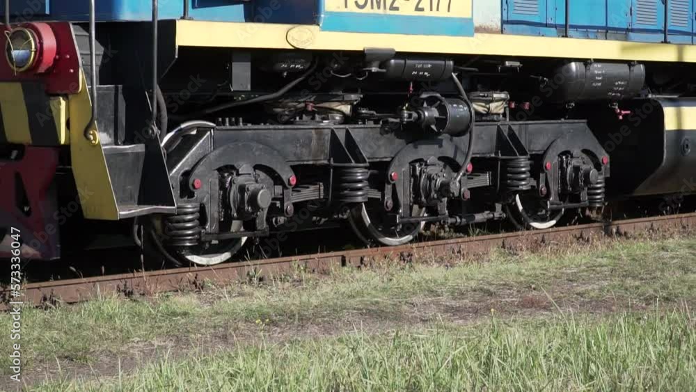 Locomotive wheels close-up. Old train locomotive. A moving train on a railroad track. Vintage technology background Locomotive wheels close-up. Old train locomotive. A moving train on a railroad track. Vintage technology background
