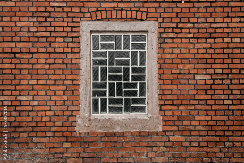 Red brick wall with glass brick window, space for background Red brick wall with glass brick window, space for background