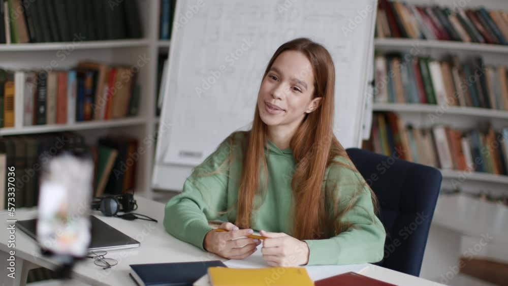 Foreign education blog. Cute young woman student recording video for social media about studying abroad on smartphone Foreign education blog. Cute young woman student recording video for social media about studying abroad on smartphone