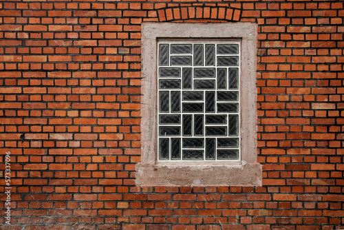 Glass brick window on brick wall, sbackground with pace for text, no person