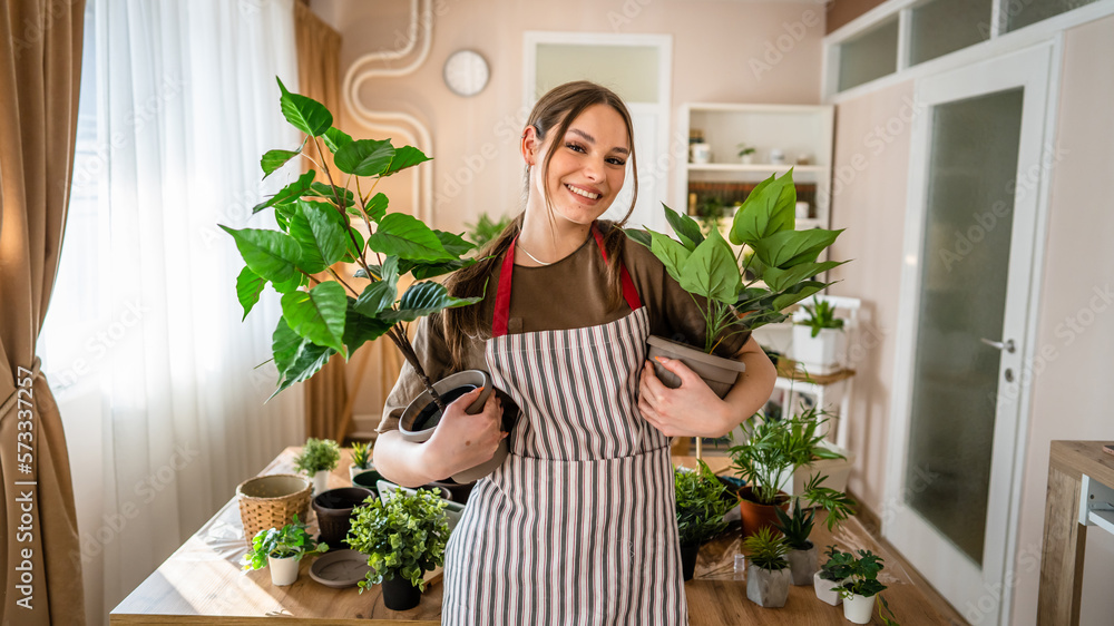One woman young caucasian female stand at home hold flower plants pot