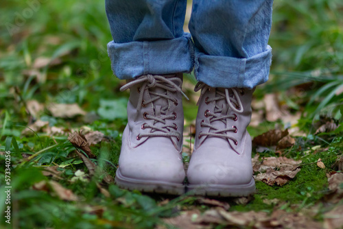 pink shoes on green grass in the forest