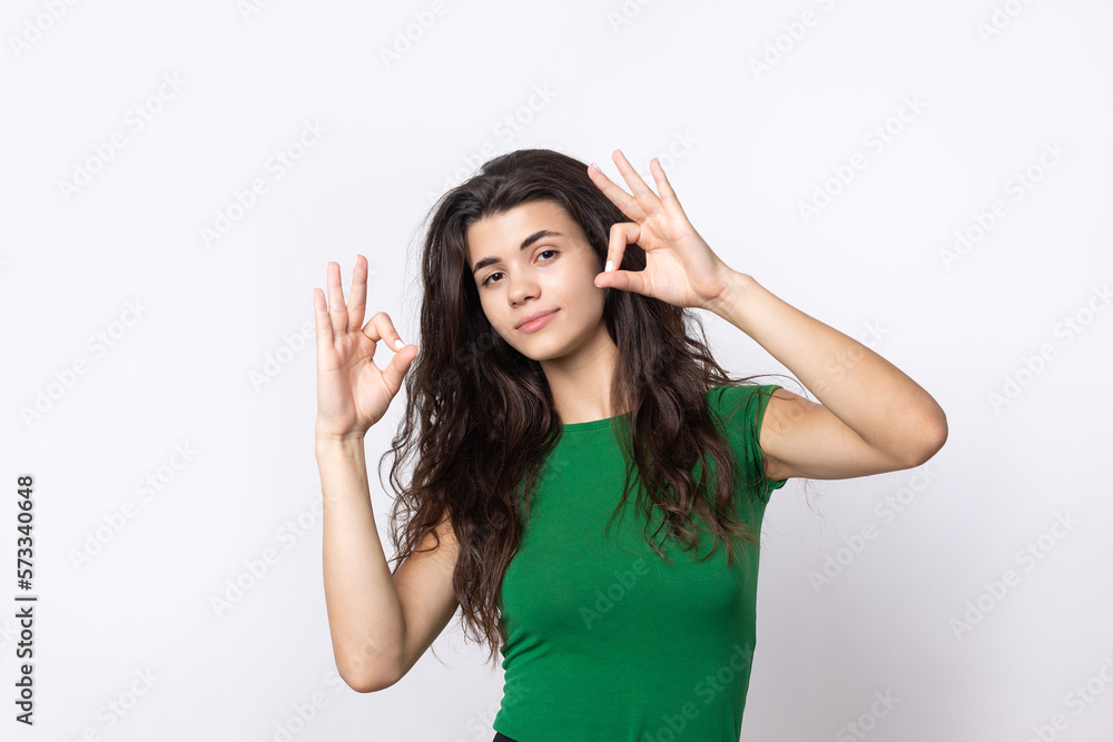 Smiling girl gesturing OK sign with her hand Smiling girl gesturing OK sign with her hand