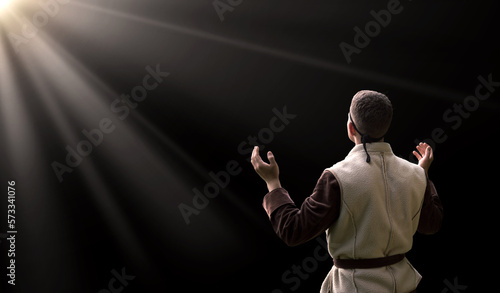 Praying man with raised hands