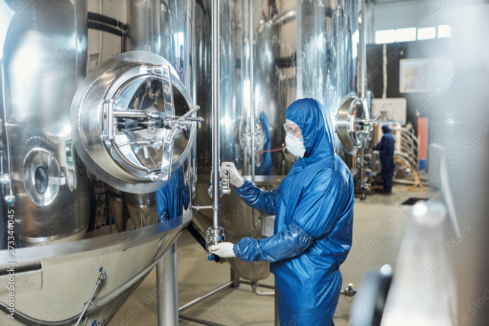 Worker wearing protective gear at chemical plant Worker wearing protective gear at chemical plant