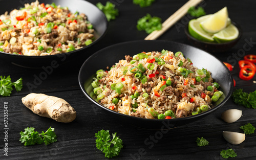 Asian Beef Fried Rice with eggs and vegetables in black bowl