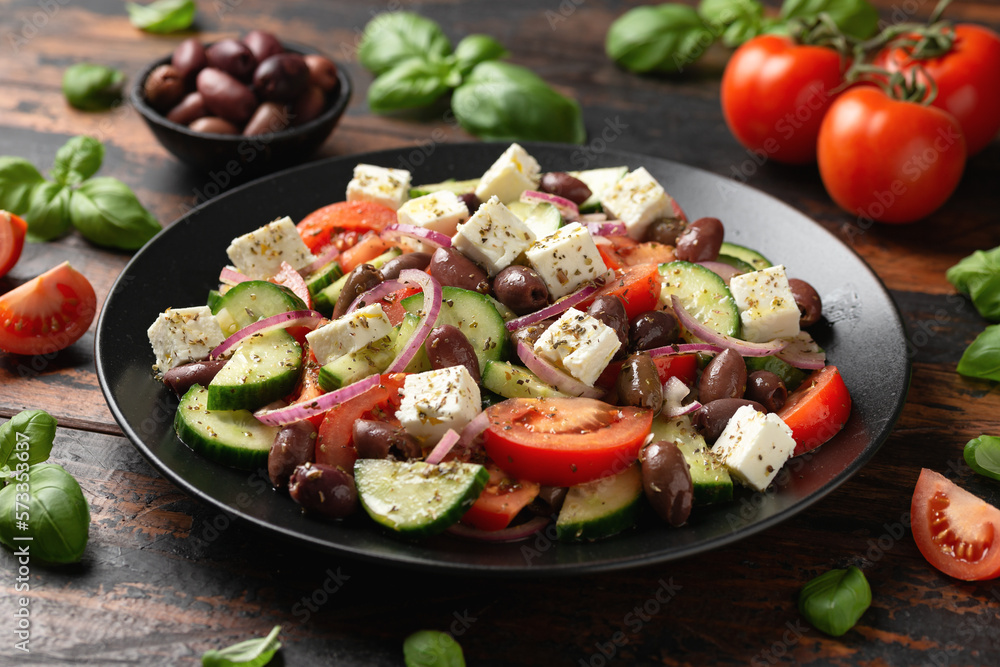 Greek salad with fresh vegetables, feta cheese, kalamata olives, dried oregano, red wine vinegar and olive oil. Healthy food.