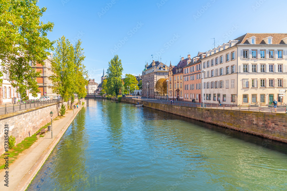 Historic buildings along the Ill River near Pont du Corbeau Bridge in the downtown district near the old town of Strasbourg, France.