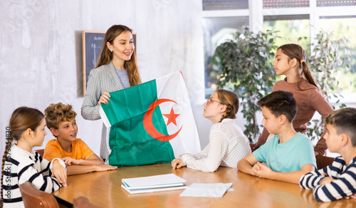 Fotografie Teacher with flag of Algeria tells story of the emergence of the state
