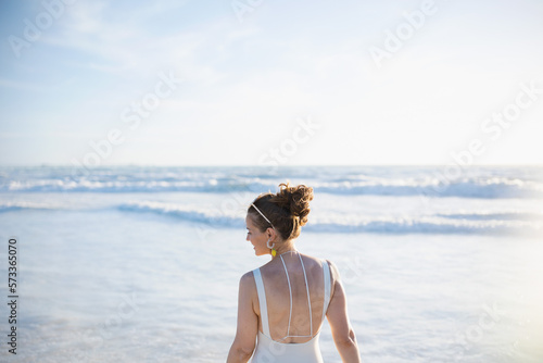 happy elegant female in white beachwear at beach relaxing © Alliance