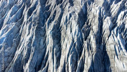 Huge glacier with pure blue ice at sunny weather. Vatnajokull glacier in Iceland. Beautiful nature abstract background. Ice texture landscape aerial view.