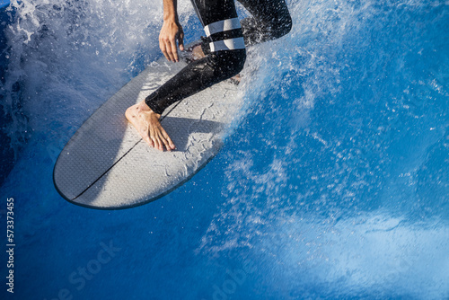 Photography A surfer looking for traction on his board on the crest of the wave