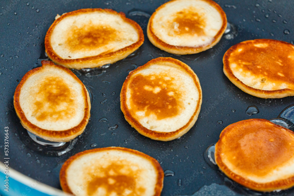 Fresh homemade pancakes flapjacks cooking on the hot pan Fresh homemade pancakes flapjacks cooking on the hot pan
