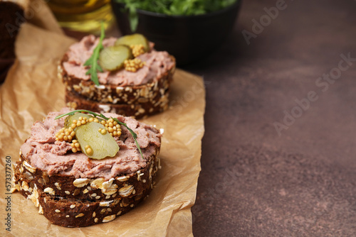 Delicious liverwurst sandwiches with pickled cucumber and mustard on grey table  closeup. Space for text