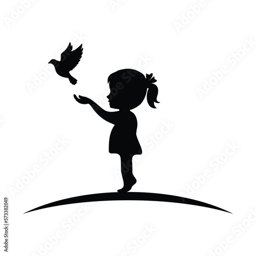 silhouette of girl releasing bird from her hands happily