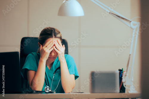 Sad Unhappy Doctor Suffering from Migraines and Burnout. Female medical doctor having problems coping with failure
 photo