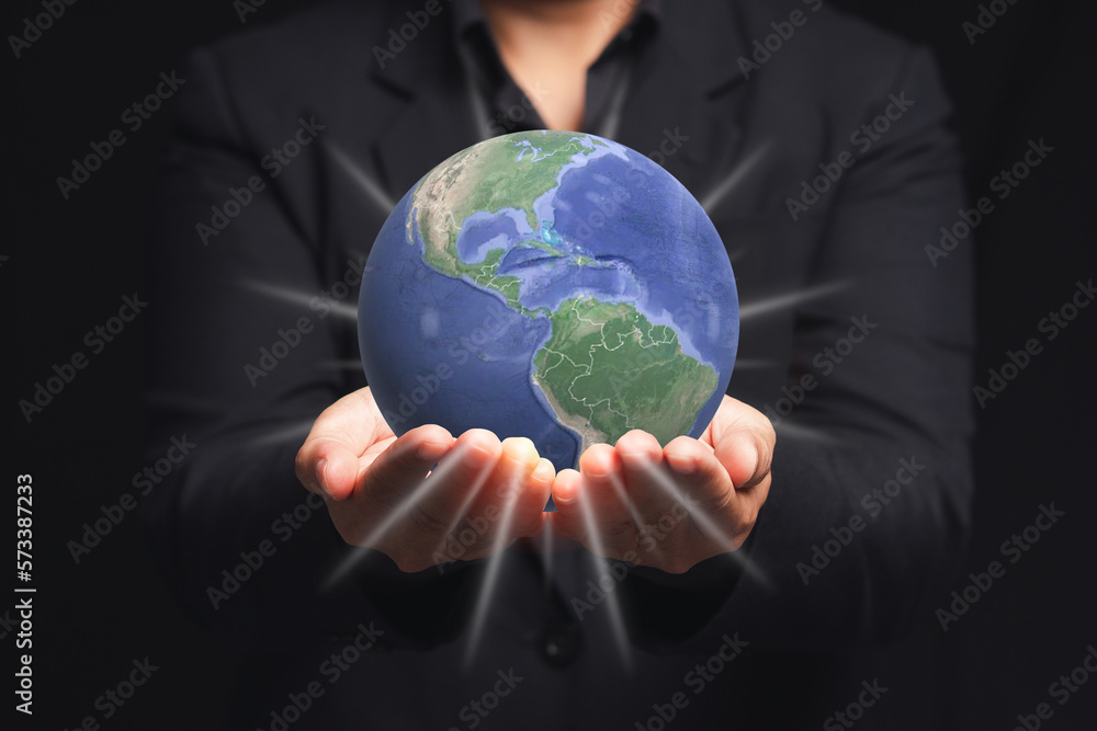The Earth on the palm businessman while standing on a black background The Earth on the palm businessman while standing on a black background
