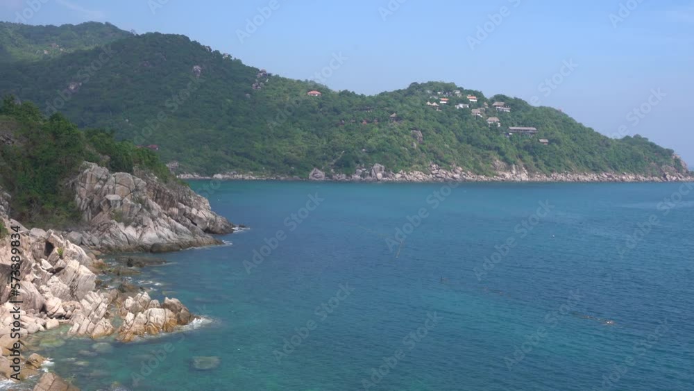 Rocky Coastline Of Koh Tao Island Hit By Pristine Ocean Waves, In Thailand. - wide shot Rocky Coastline Of Koh Tao Island Hit By Pristine Ocean Waves, In Thailand. - wide shot