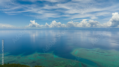 Aerial drone of the island of Cebu from the sea. Blue ocean and sky with clouds. Seascape in the tropics.