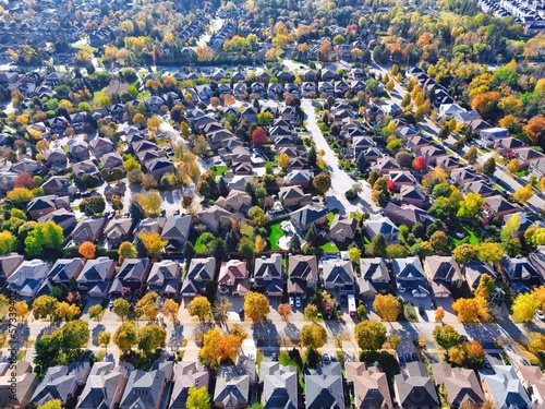 Aerial view of residential community neighborhood under autumn fall colors. Typical North America, Canada houses and streets drone shot background
