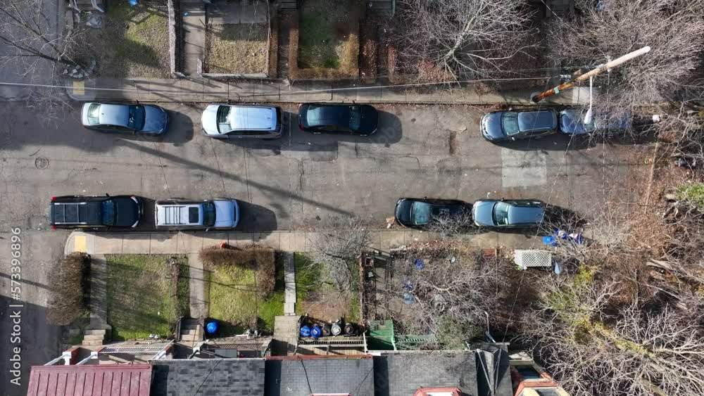 Top down aerial view of housing neighborhood in city suburb. American houses in urban outskirt with street parking. Top down aerial view of housing neighborhood in city suburb. American houses in urban outskirt with street parking.