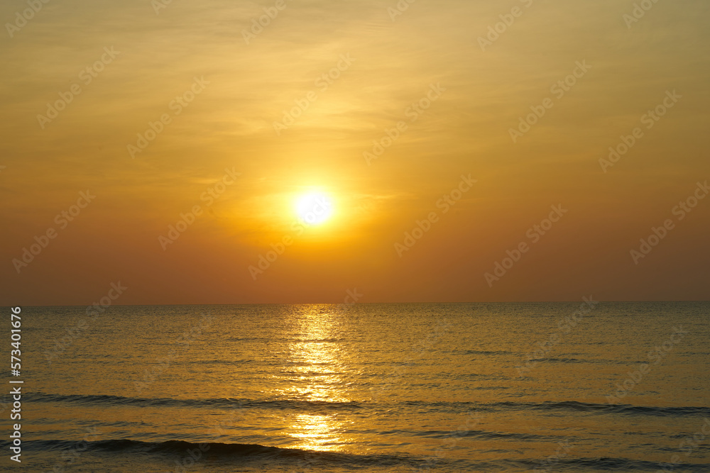 yellow sun set at beach skyline on orange background