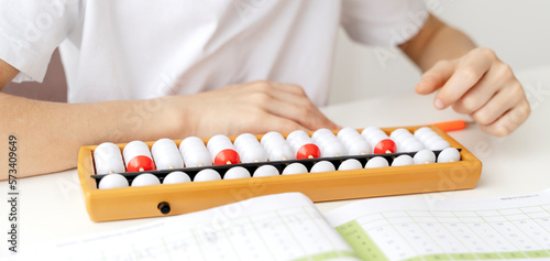 The boy is engaged in abacus, mental arithmetic for children