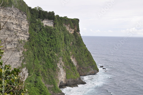 Uluwatu beach in Bali with high cliffs next to it