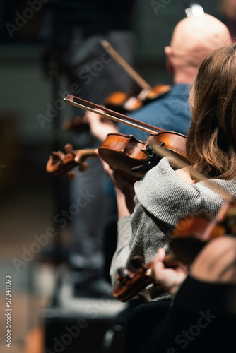 Musicians playing the viola or violin in a string section of a symphony orchestra