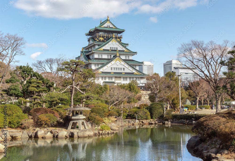 Green and white traditional Japanese architecture building and garden park and trees of the Osaka Castle in Osaka Japan Green and white traditional Japanese architecture building and garden park and trees of the Osaka Castle in Osaka Japan