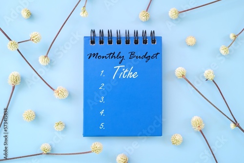 Tithe and offering as part of budget priority concept. Notepad with written monthly budget. photo