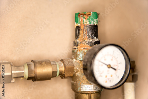 Decaying backwash water filter with pressure regulator and manometer that needs urgent replacement