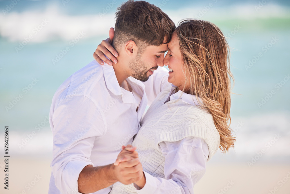 Fototapeta premium Love, dance and happy with couple on beach for date, romance and anniversary celebration. Smile, bonding and affectionate with man and woman on holiday for hug, vacation and happiness together