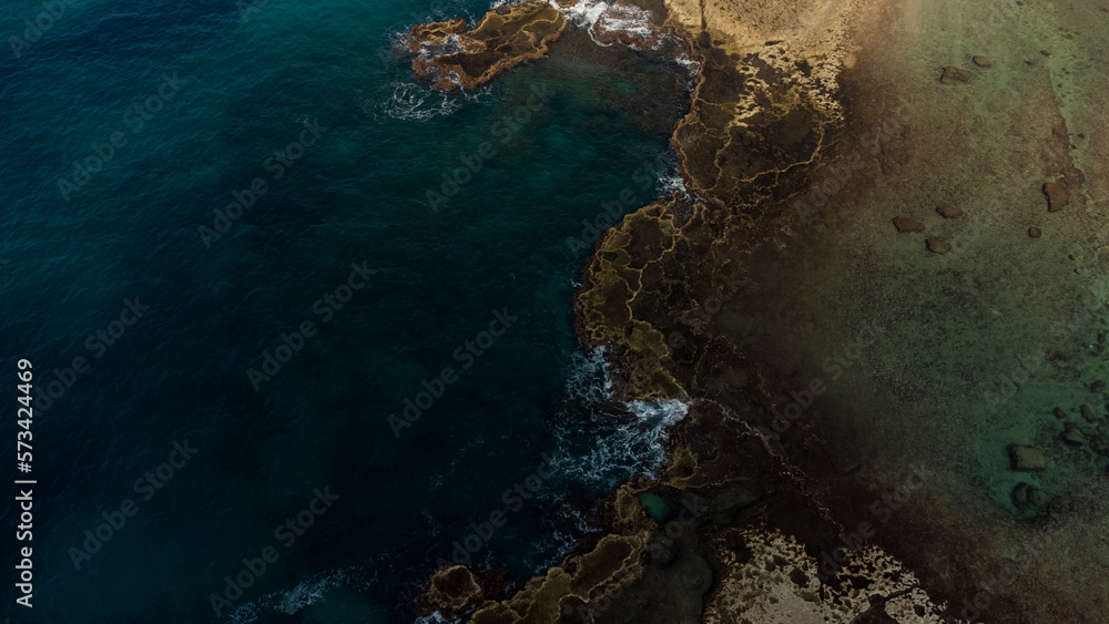 Abstract natural background with turquoise sea and rocks aerial view. 