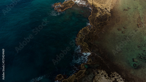 Abstract natural background with turquoise sea and rocks aerial view. © NS