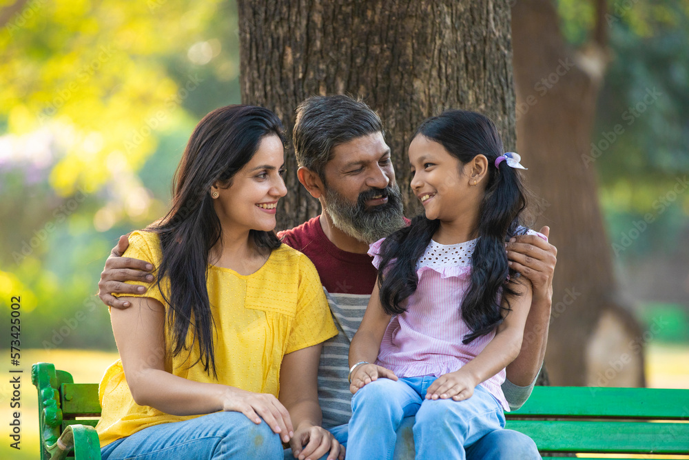 Happy indian couple with his little girl at garden. Stock Photo | Adobe ...