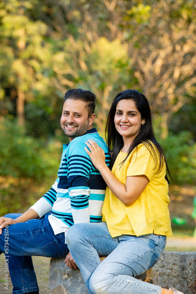 Fototapeta premium Young Indian couple sitting at park.