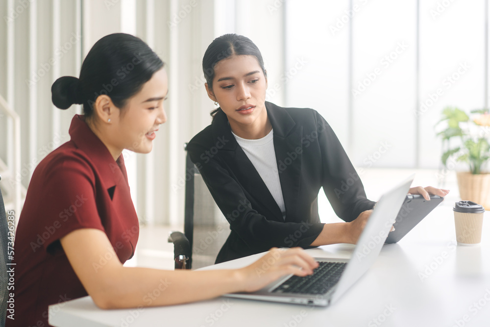 Two business asian woman using laptop computer in office Two business asian woman using laptop computer in office