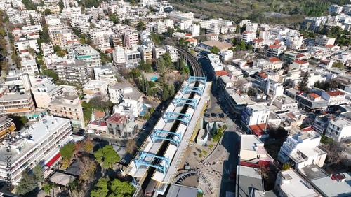 Drone footage of the metro station and the railway tracks in Marousi, a suburb in the north of Athens, Greece photo