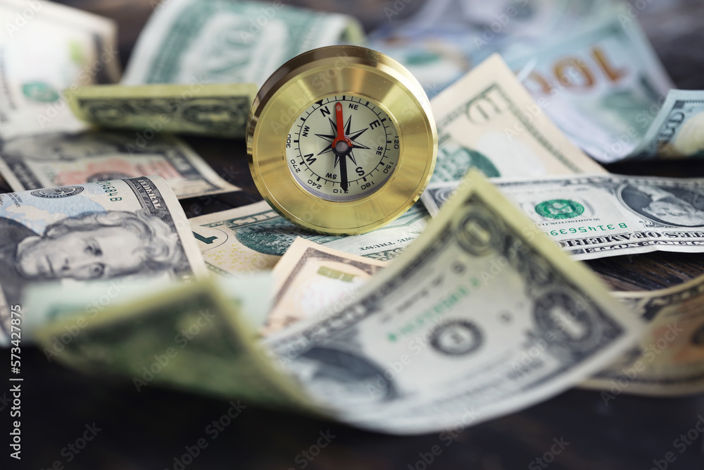 Money bill with golden Compass. Bullets and cartridge cases as a military concept. Close up US Currency and compass. business, financial idea, concept, symbol of crisis, inflation Money bill with golden Compass. Bullets and cartridge cases as a military concept. Close up US Currency and compass. business, financial idea, concept, symbol of crisis, inflation
