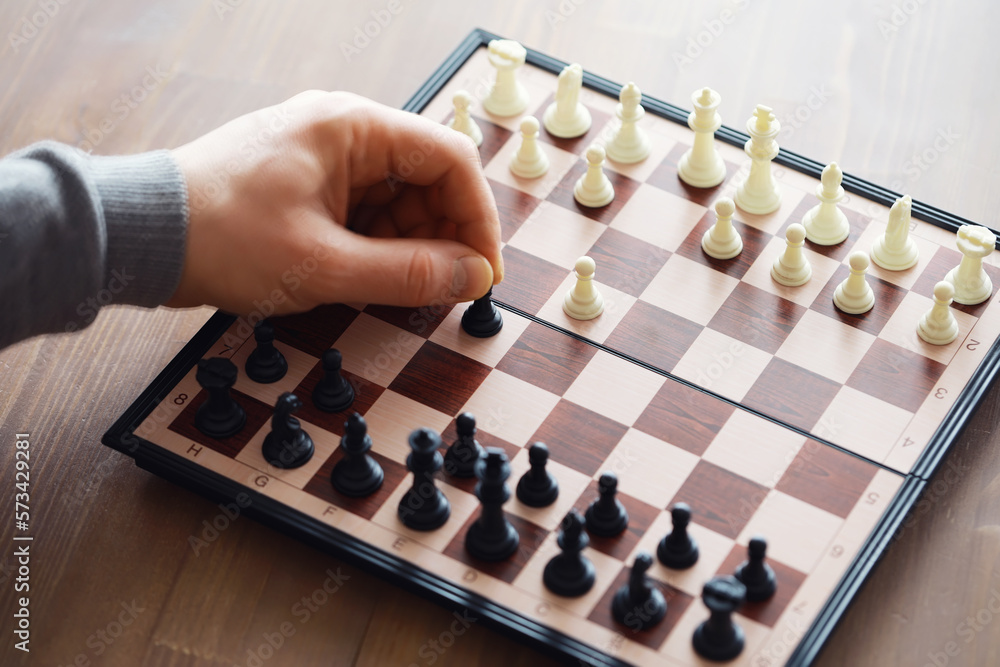 Hand playing game of chess, competition, strategy, battle, play Hand playing game of chess, competition, strategy, battle, play