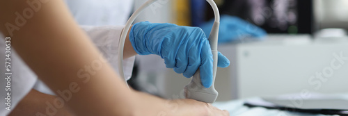Slika na platnu Doctor makes ultrasound of wrist in clinic closeup